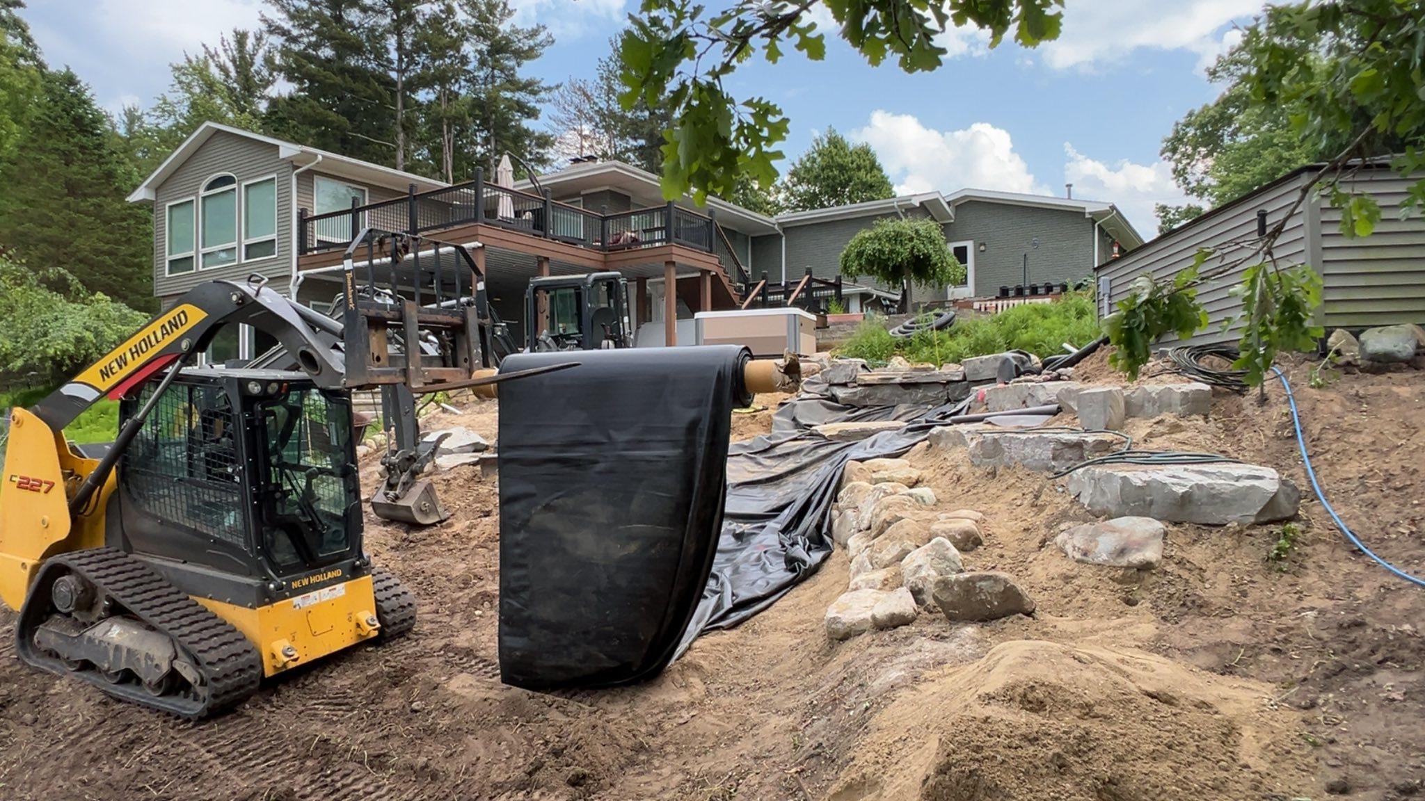 NorthLawn water feature build in progress with equipment and stonework